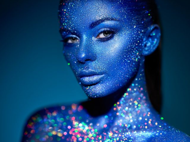 Portrait of beautiful woman with sparkles on her face